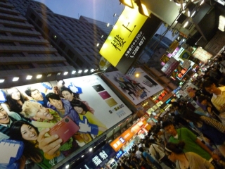 Brightly lit billboard want you to buy, buy, buy